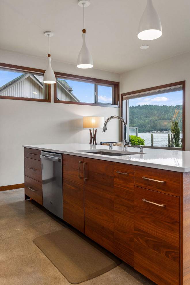 Medium sized traditional kitchen/diner in Seattle with flat-panel cabinets, engineered stone countertops, stainless steel appliances and an island.