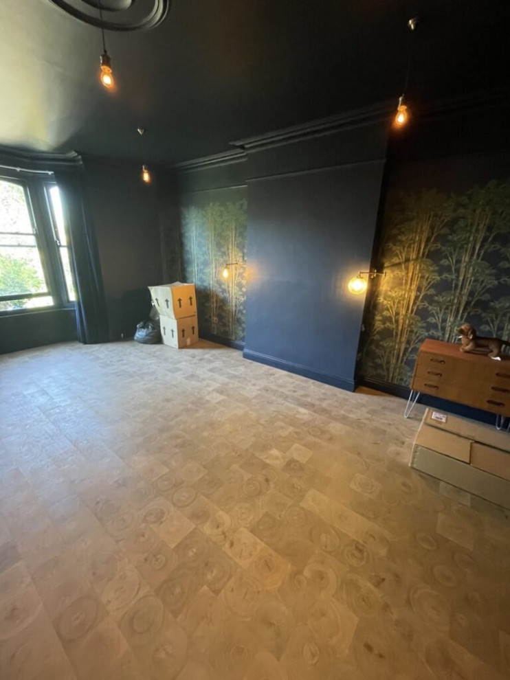 Inspiration for a large formal and cream and black enclosed living room feature wall in London with black walls, ceramic flooring, no fireplace, a concrete fireplace surround, no tv, brown floors, a wood ceiling and wainscoting.