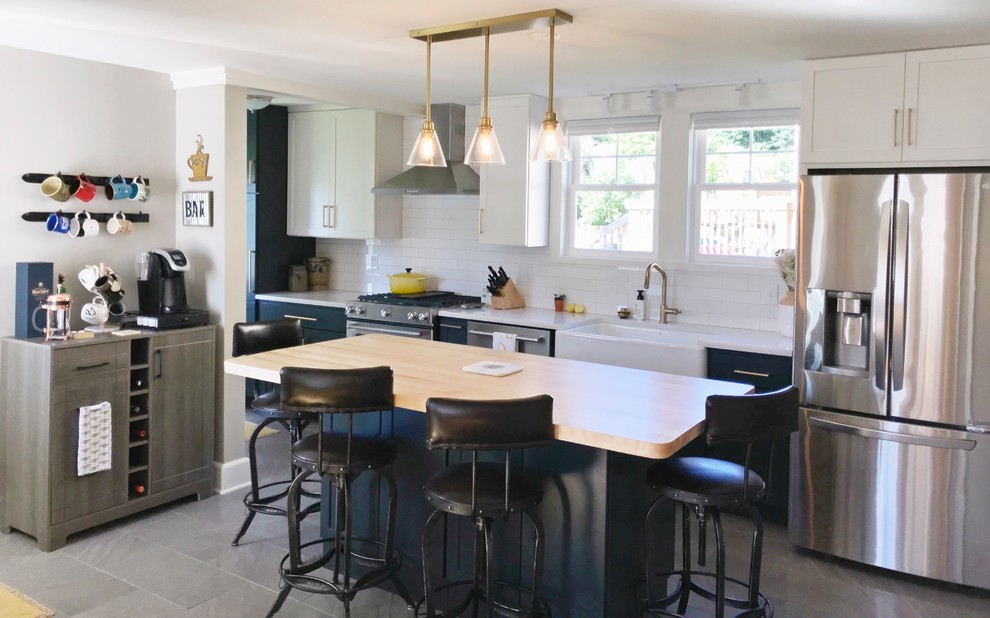 Inspiration for a transitional gray floor kitchen remodel with a farmhouse sink, quartz countertops and stainless steel appliances