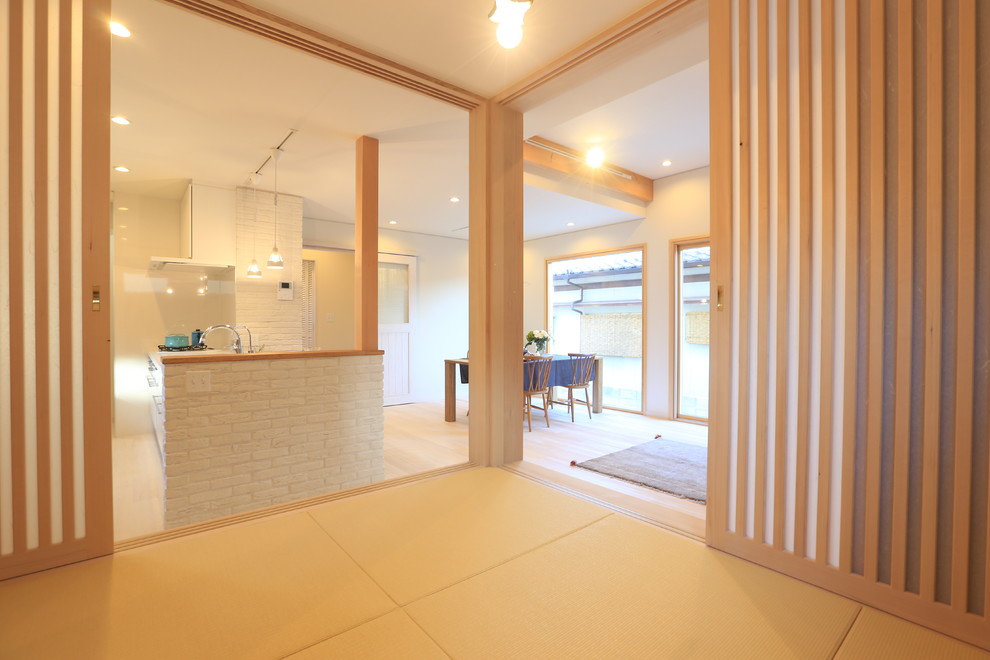 This is an example of a scandinavian family room in Other with white walls, tatami floors and beige floor.