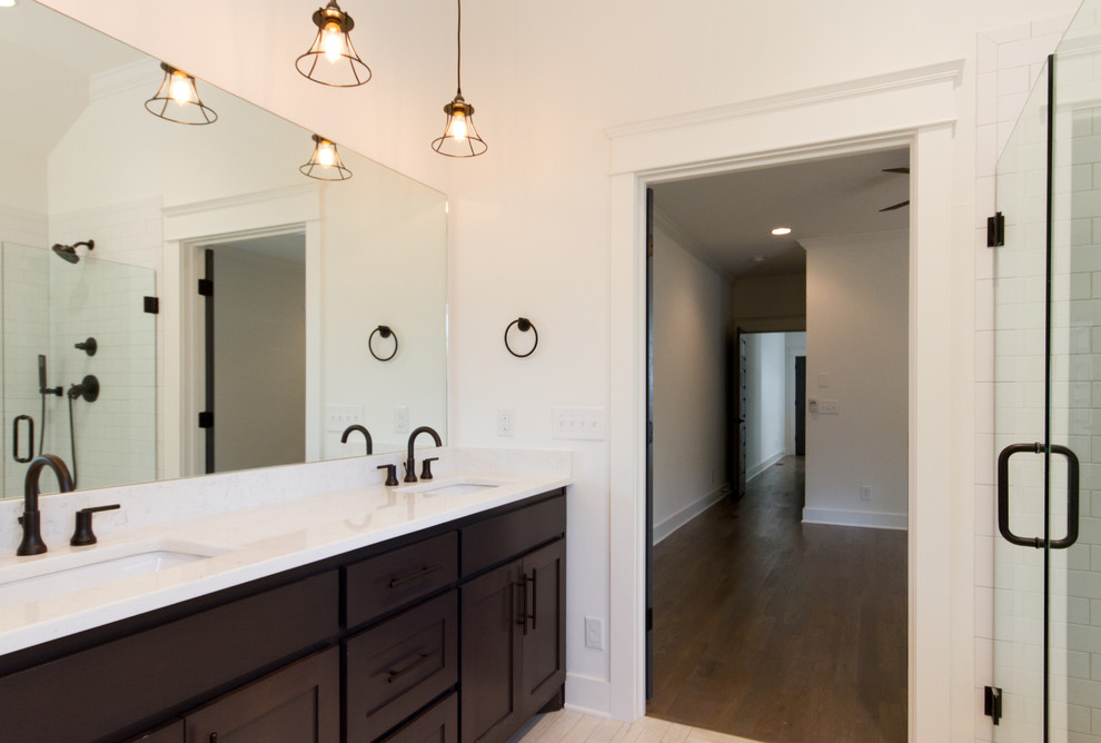Design ideas for a mid-sized industrial master bathroom in Nashville with an undermount sink, shaker cabinets, dark wood cabinets, quartzite benchtops, an open shower, a two-piece toilet, white tile, subway tile, white walls and porcelain floors.
