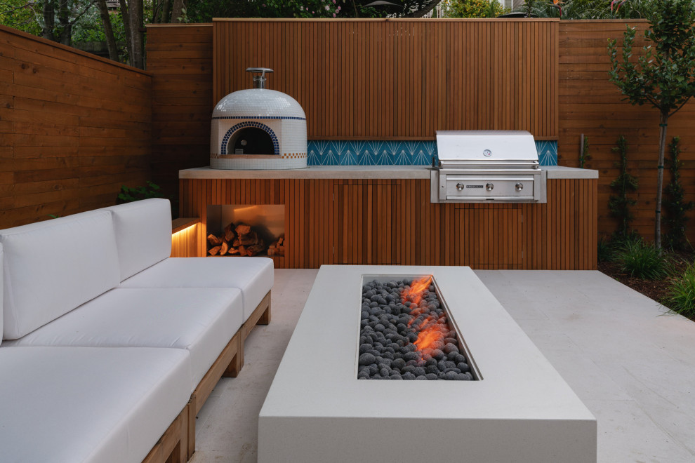 Design ideas for a small modern back patio in San Francisco with a fire feature and concrete paving.