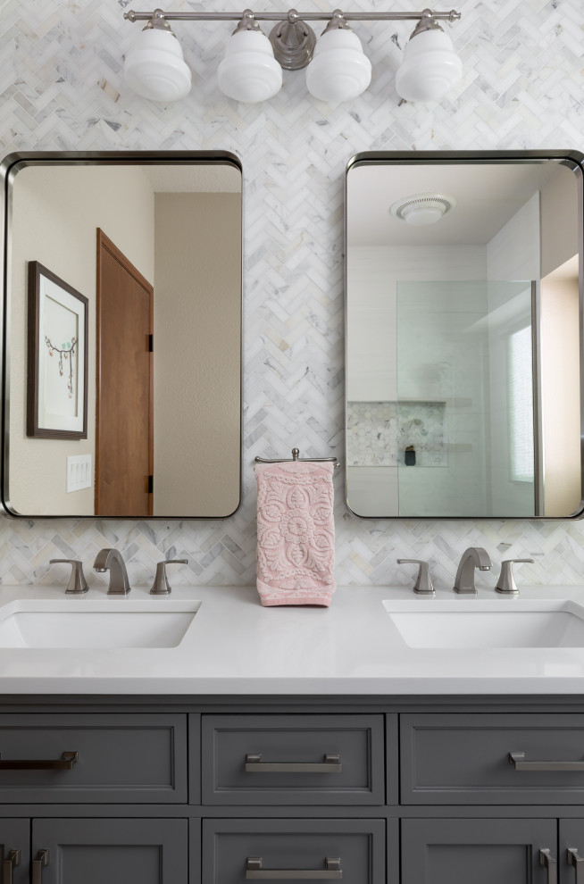 Photo of a mid-sized transitional bathroom in Seattle with recessed-panel cabinets, grey cabinets, an alcove shower, a one-piece toilet, white tile, marble, beige walls, wood-look tile, an undermount sink, engineered quartz benchtops, grey floor, a hinged shower door, a double vanity, a freestanding vanity and white benchtops.