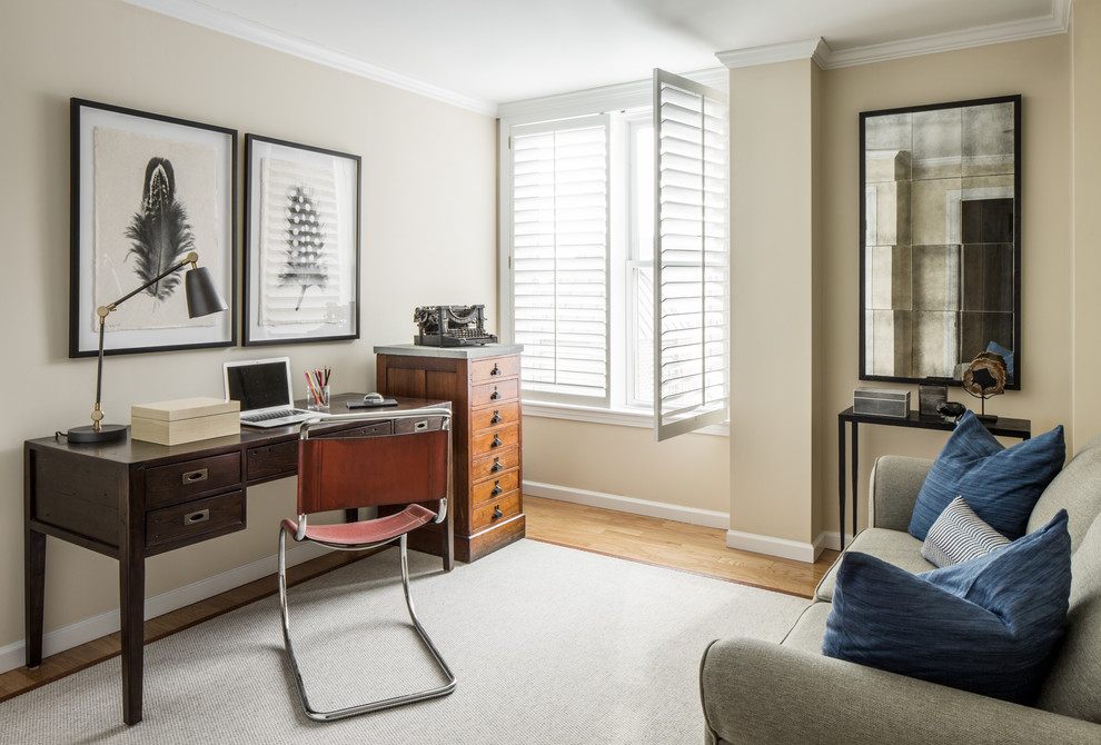 Transitional home office in Boston with beige walls, medium hardwood floors and a freestanding desk.