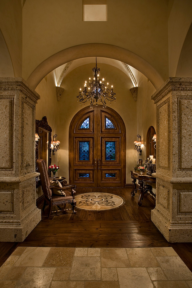 Design ideas for an expansive traditional foyer in Phoenix with beige walls, medium hardwood floors, a double front door and a glass front door.