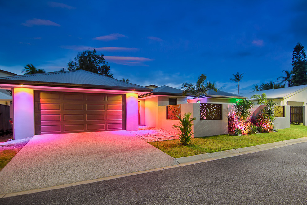 Mid-sized contemporary one-storey grey exterior in Cairns with a hip roof.