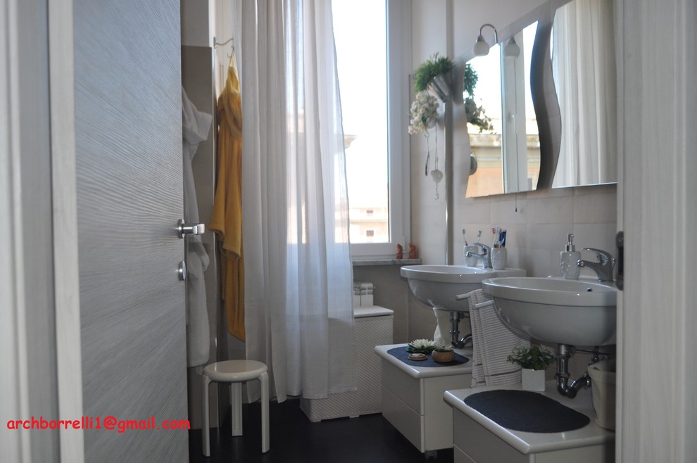 Mid-sized modern 3/4 bathroom in Rome with flat-panel cabinets, white cabinets, a corner shower, beige tile, porcelain tile, beige walls, porcelain floors, black floor and a sliding shower screen.