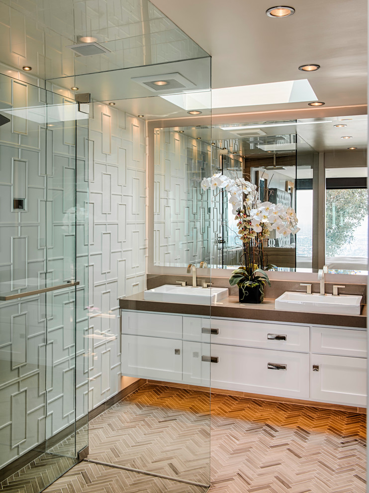 This is an example of a mid-sized transitional master bathroom in Los Angeles with a vessel sink, shaker cabinets, white cabinets, a curbless shower, beige tile, white walls, ceramic tile, porcelain floors, engineered quartz benchtops, beige floor and a hinged shower door.