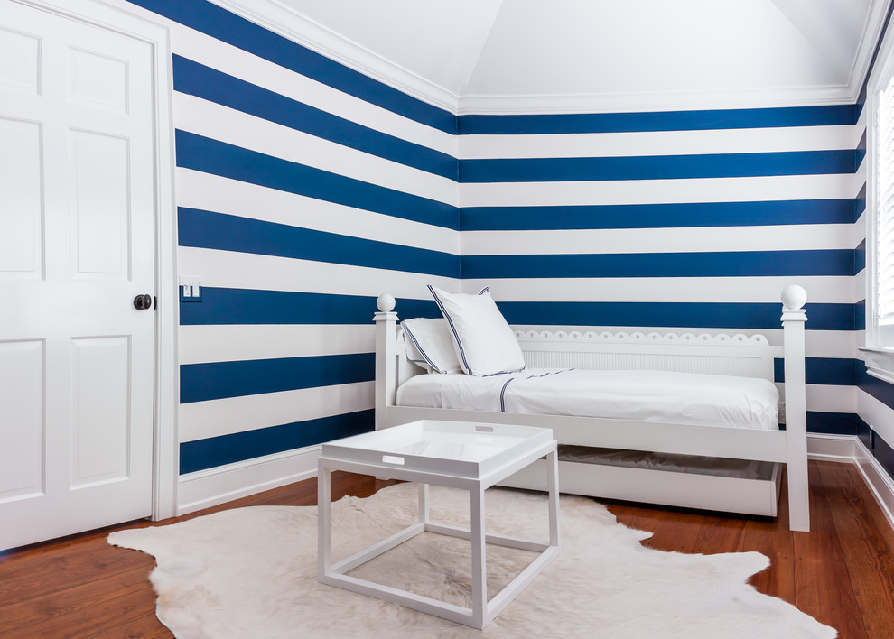 Photo of a small beach style kids' bedroom for boys in New York with blue walls and medium hardwood floors.