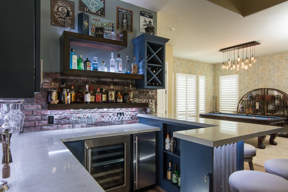 This is an example of a large country u-shaped seated home bar in Los Angeles with no sink, open cabinets, blue cabinets, red splashback, medium hardwood floors, quartzite benchtops, brick splashback and brown floor.