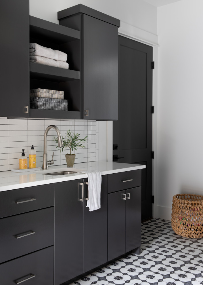 This is an example of a transitional laundry room in Austin.
