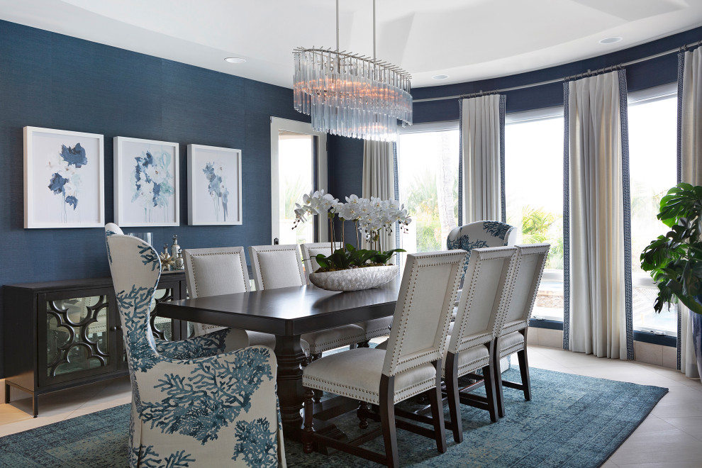 This is an example of a mid-sized transitional separate dining room in Orange County with blue walls, limestone floors, coffered and wallpaper.