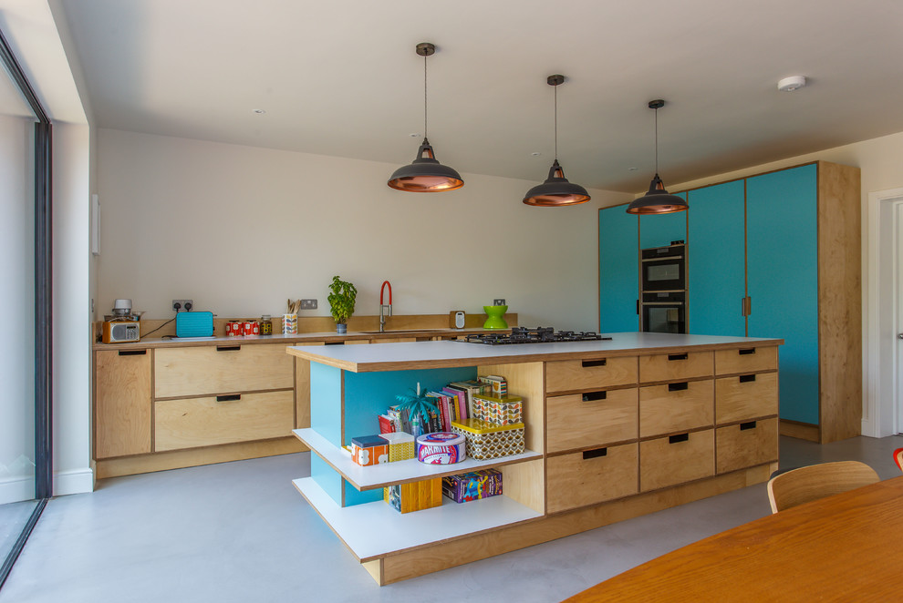 Inspiration for a large eclectic open plan kitchen in Sussex with a double-bowl sink, open cabinets, light wood cabinets, laminate benchtops, beige splashback, timber splashback, black appliances, concrete floors, with island, grey floor and white benchtop.