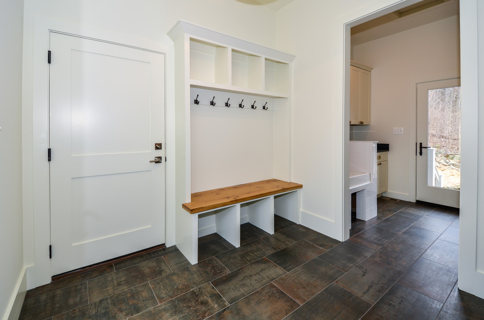 This is an example of a mid-sized scandinavian mudroom in DC Metro with white walls, porcelain floors, a single front door, a glass front door and multi-coloured floor.