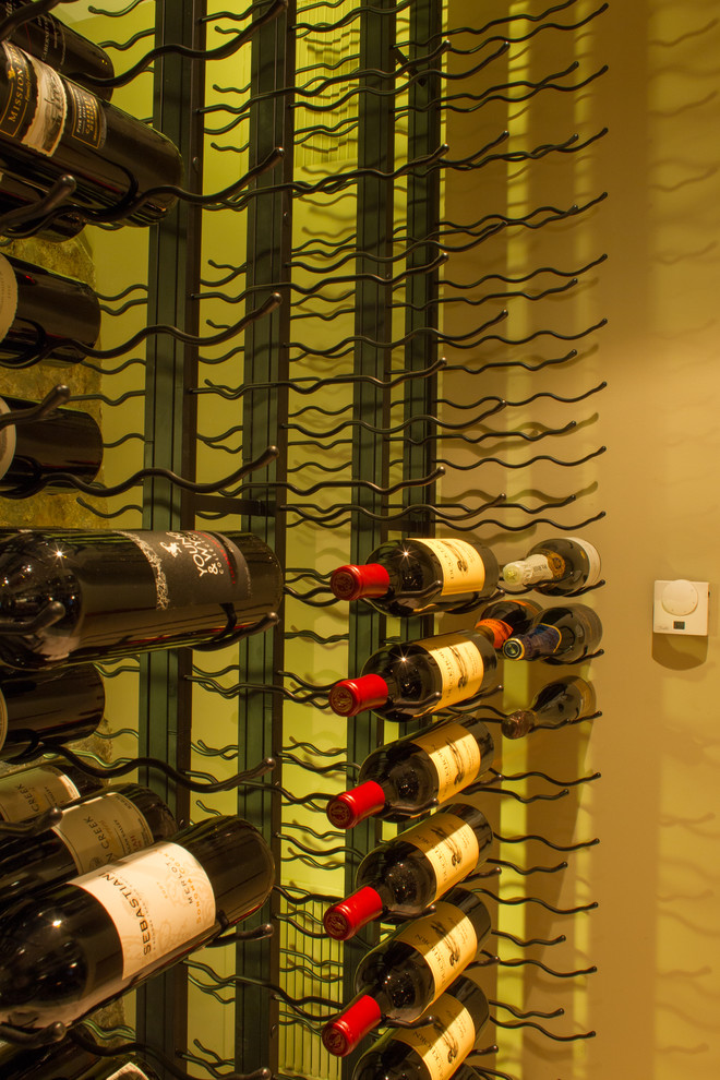 Large modern wine cellar in Vancouver with storage racks.