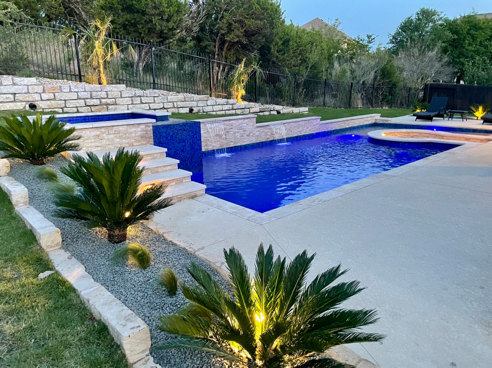 Pool fountain - large transitional backyard stone and rectangular pool fountain idea in Austin