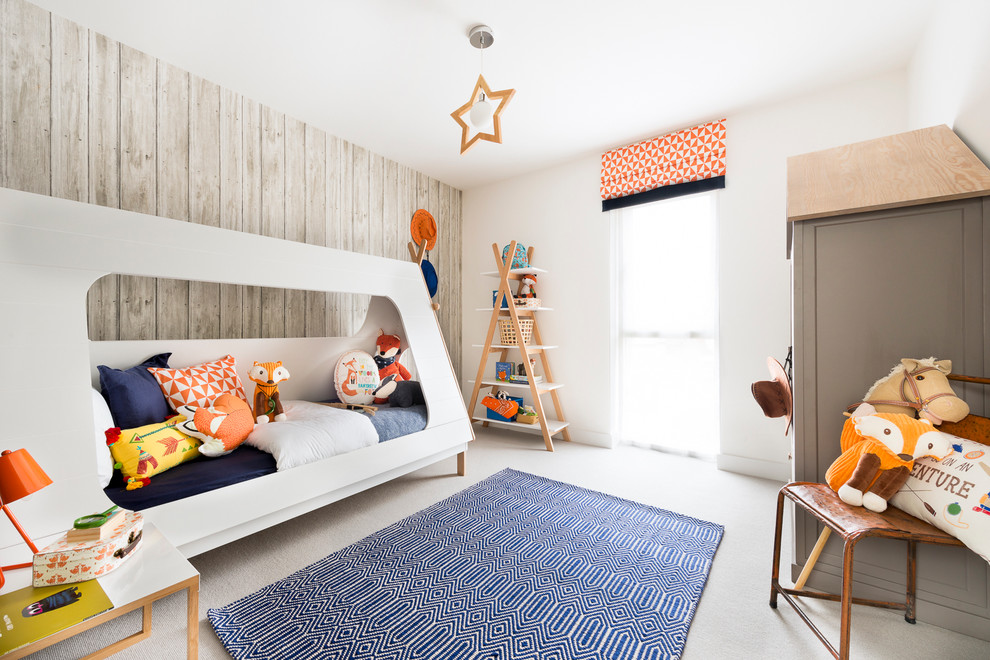 Inspiration for a mid-sized scandinavian gender-neutral kids' bedroom for kids 4-10 years old in Hampshire with white walls and carpet.