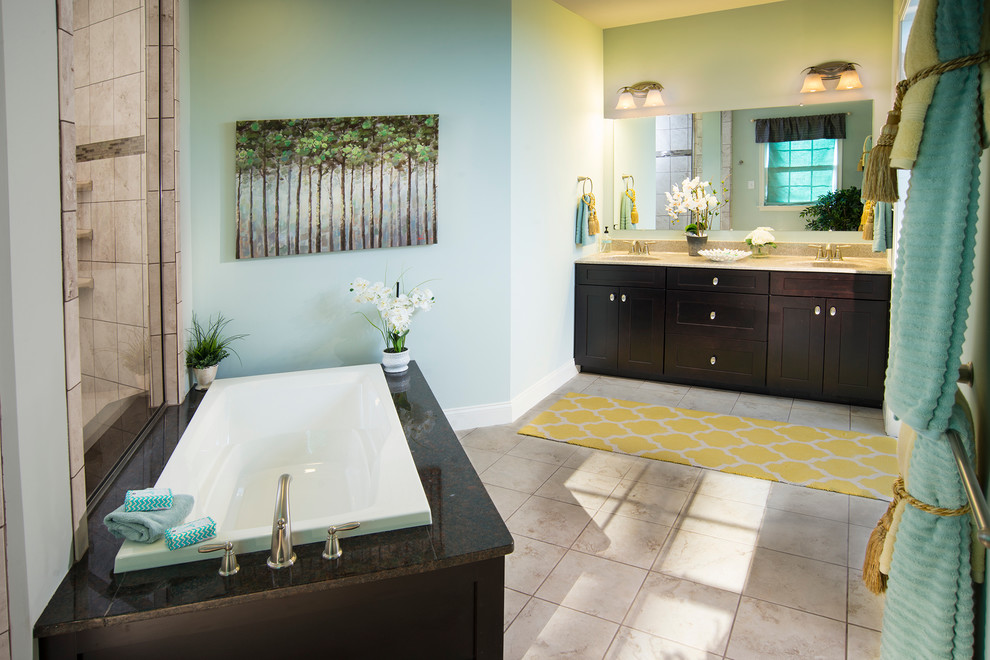 Mid-sized transitional master bathroom in Other with recessed-panel cabinets, dark wood cabinets, a drop-in tub, an alcove shower, beige tile, ceramic tile, blue walls, ceramic floors, an integrated sink and granite benchtops.