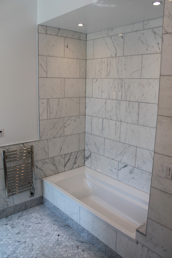 Photo of a large modern master bathroom in New York with white walls, mosaic tile floors, an alcove tub, an alcove shower, a one-piece toilet, mosaic tile and a wall-mount sink.