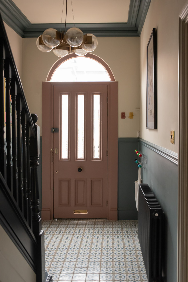 This is an example of a victorian entrance in Other with porcelain flooring.