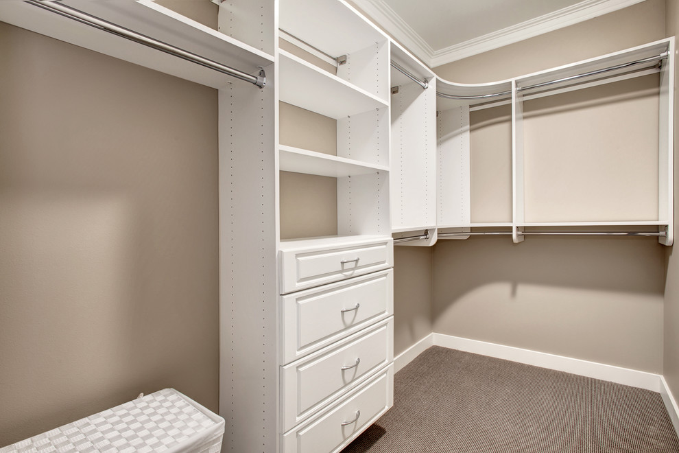 Design ideas for an arts and crafts gender-neutral walk-in wardrobe in Seattle with shaker cabinets, white cabinets and carpet.