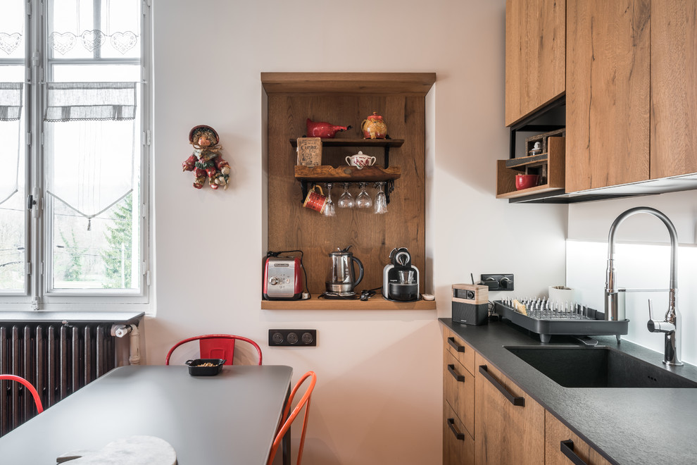 Inspiration for a mid-sized traditional galley kitchen in Lyon with an undermount sink, tile benchtops, white splashback, glass sheet splashback, stainless steel appliances, terra-cotta floors, no island and orange floor.