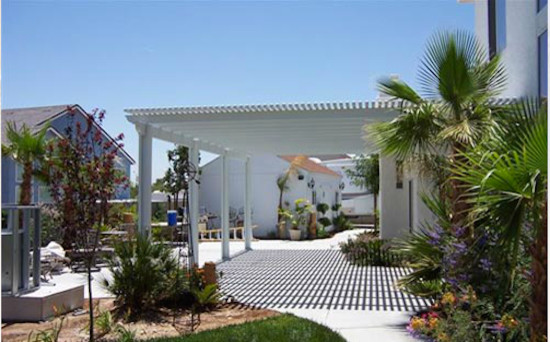 Inspiration for a small transitional backyard deck remodel in Las Vegas with a roof extension