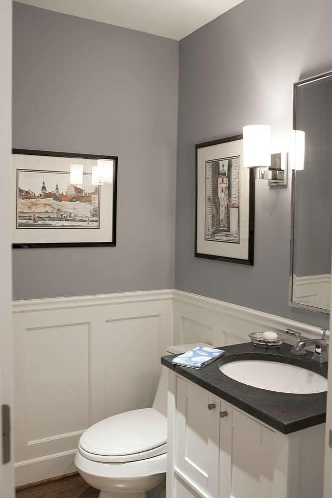 Design ideas for a traditional powder room in New York with an undermount sink, shaker cabinets, white cabinets, soapstone benchtops, a one-piece toilet and grey benchtops.