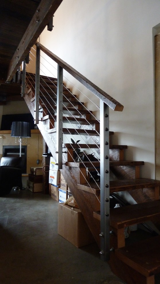Staircase - mid-sized modern wooden u-shaped open and cable railing staircase idea in Vancouver
