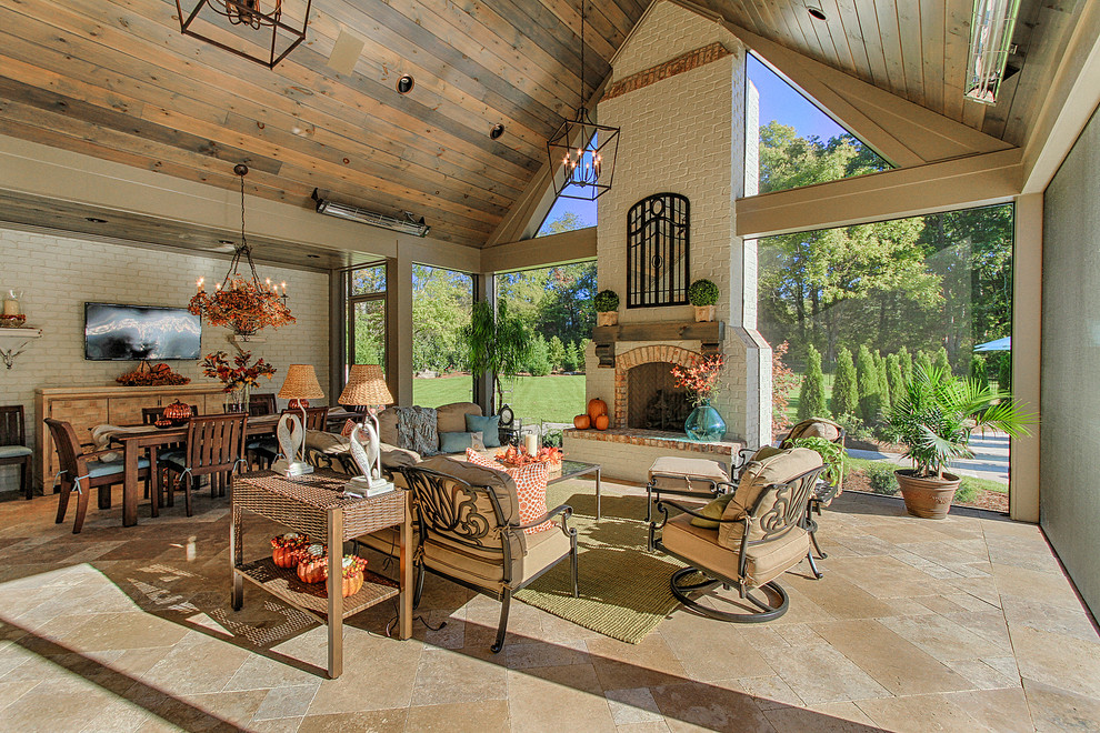 Photo of an expansive country patio in Other with a fire feature and a roof extension.