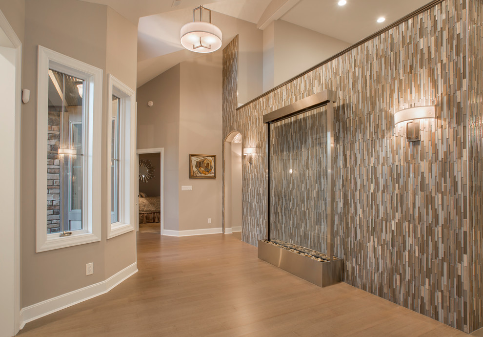 Photo of a large modern foyer in Cincinnati with brown walls and bamboo floors.