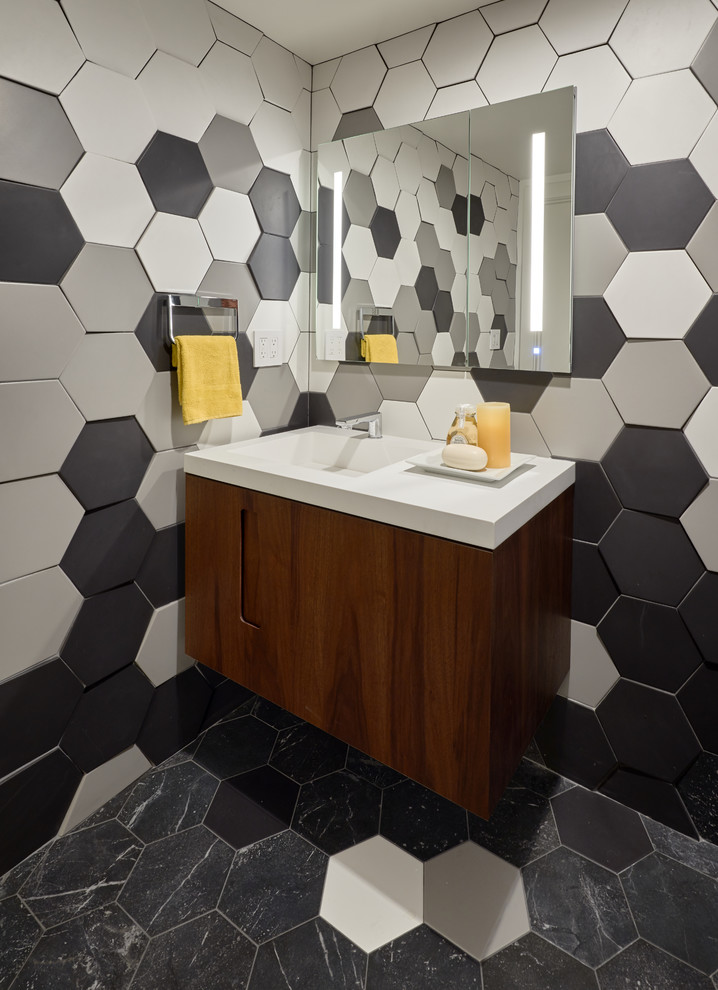 Photo of a contemporary bathroom in San Francisco with flat-panel cabinets, dark wood cabinets, black tile, black and white tile, gray tile, multi-coloured tile, white tile, multi-coloured walls, an integrated sink, multi-coloured floor and white benchtops.