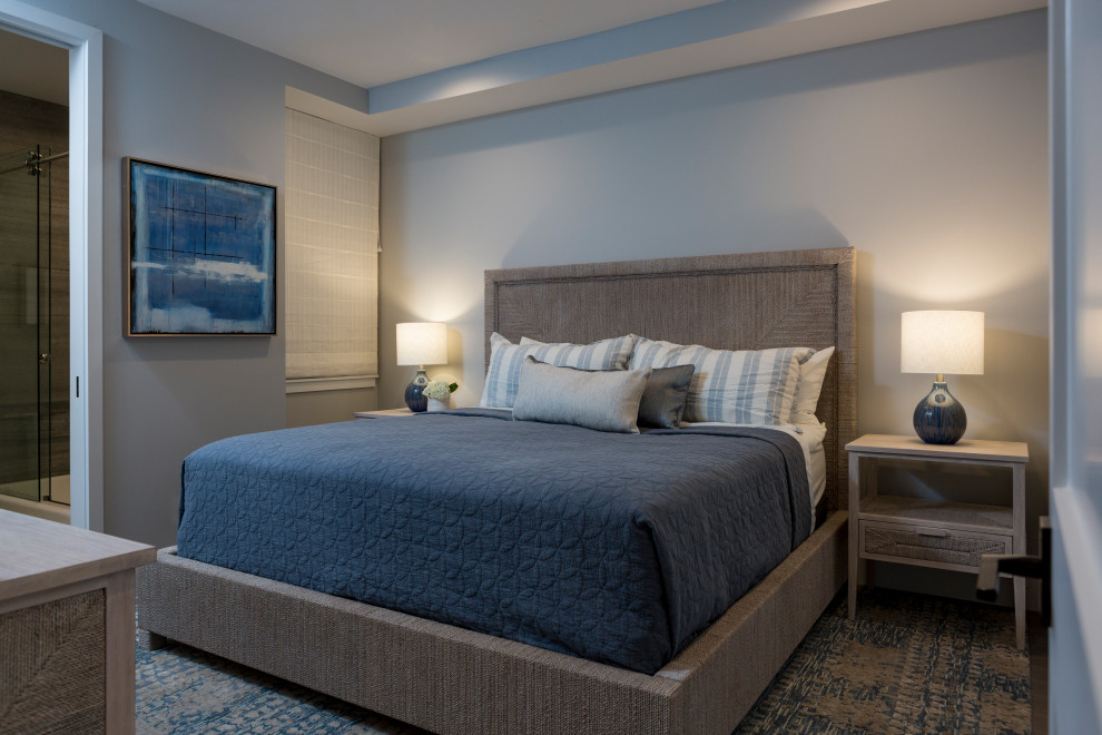 Small coastal guest bedroom in Los Angeles with grey walls, medium hardwood flooring and grey floors.