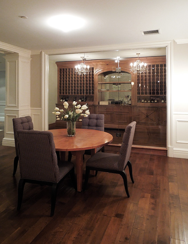 Photo of a mid-sized traditional wine cellar in Chicago with medium hardwood floors, storage racks and brown floor.