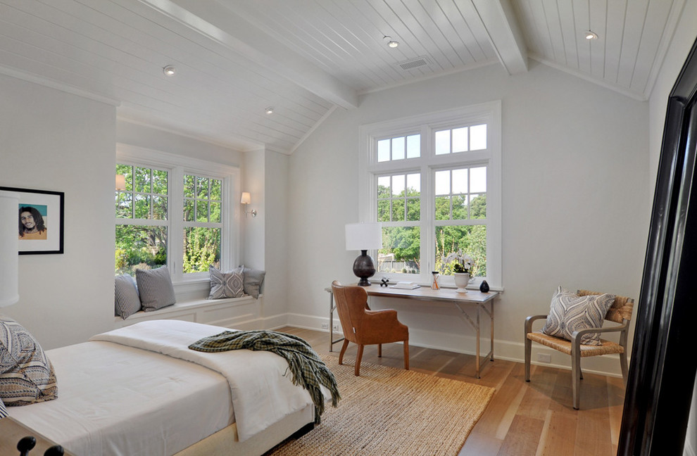 Country bedroom in San Francisco with white walls and medium hardwood floors.