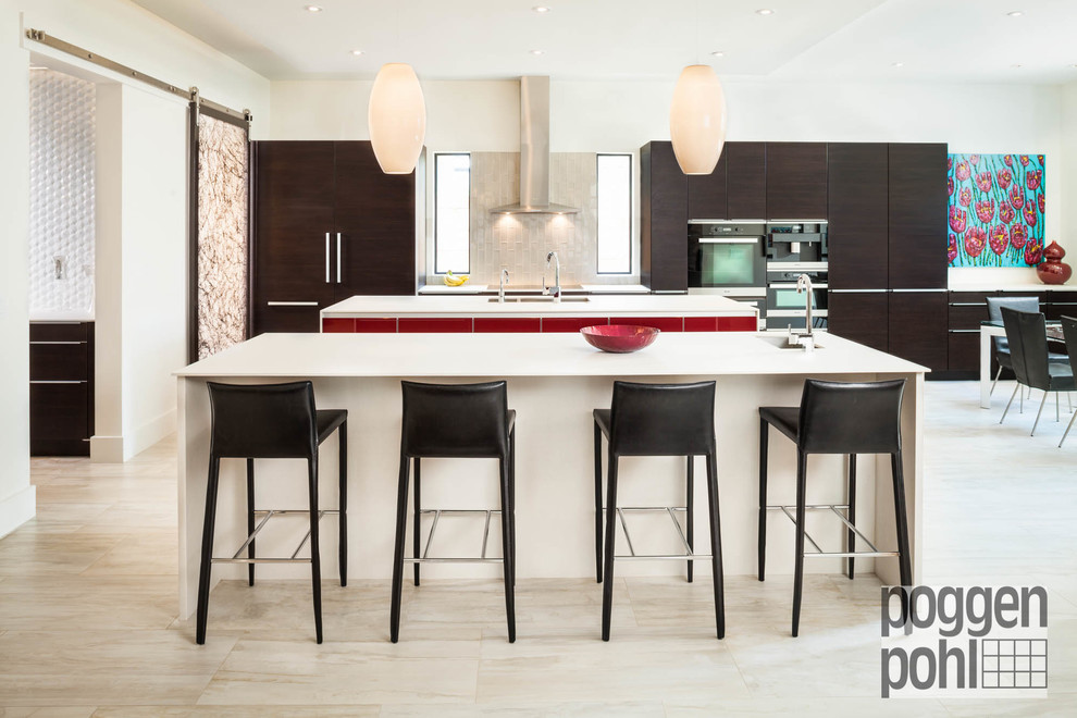 Inspiration for an expansive contemporary single-wall open plan kitchen in Houston with flat-panel cabinets, brown cabinets, beige splashback, black appliances, travertine floors, multiple islands, an undermount sink, quartz benchtops and glass tile splashback.