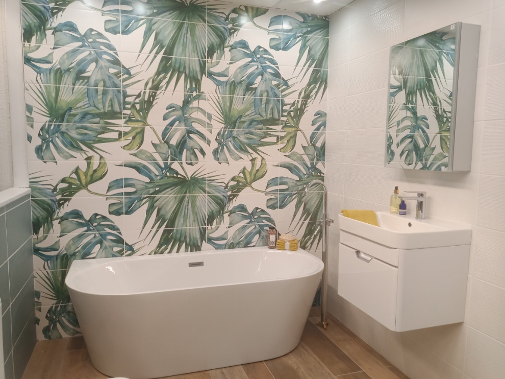 Photo of a large world-inspired family bathroom in Devon with a freestanding bath, a one-piece toilet, ceramic tiles and white walls.
