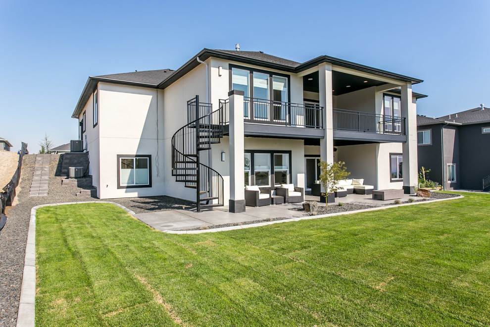 Inspiration for a large contemporary backyard deck remodel in Seattle with a roof extension