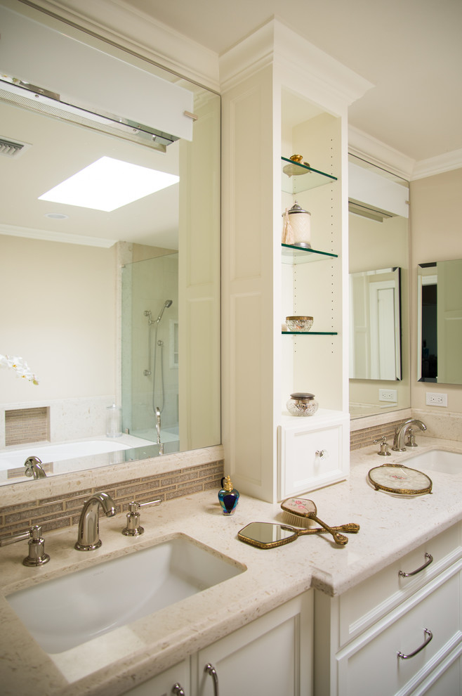 This is an example of a mid-sized transitional master bathroom in Los Angeles with recessed-panel cabinets, white cabinets, an undermount tub, a corner shower, a two-piece toilet, beige tile, gray tile, matchstick tile, beige walls, linoleum floors, an undermount sink and engineered quartz benchtops.