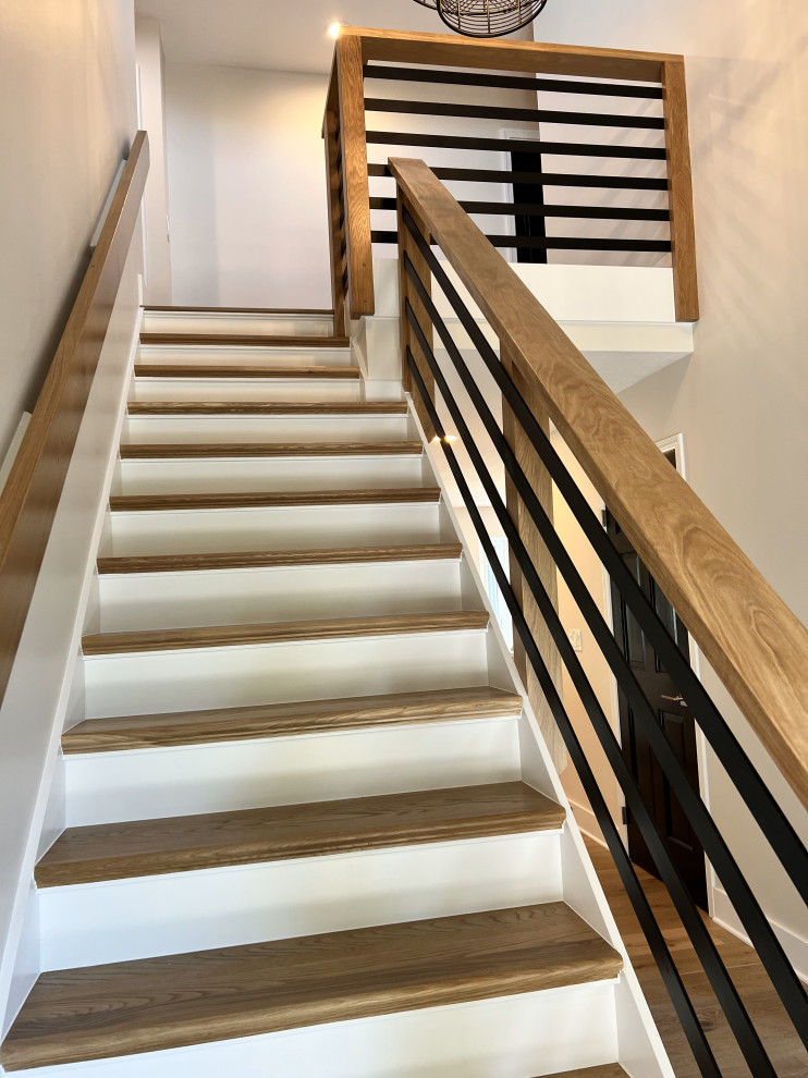 This is an example of a transitional wood straight staircase in Columbus with wood risers and mixed railing.