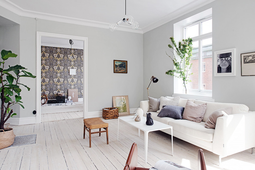 Photo of a mid-sized scandinavian formal open concept living room in Gothenburg with grey walls, light hardwood floors, no fireplace and no tv.