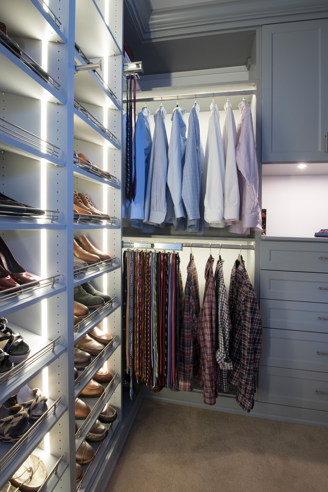 Inspiration for a large transitional gender-neutral walk-in wardrobe in Chicago with recessed-panel cabinets, grey cabinets and carpet.