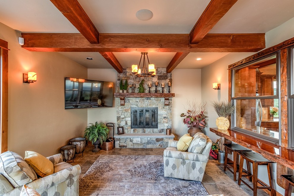 Inspiration for a mid-sized country enclosed family room in Portland with a home bar, beige walls, ceramic floors, a standard fireplace, a stone fireplace surround and brown floor.