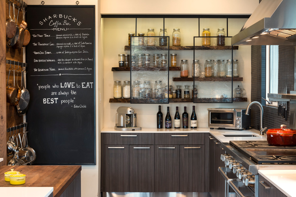 Large urban l-shaped kitchen photo in Dallas with an undermount sink, flat-panel cabinets, dark wood cabinets, stainless steel appliances, an island, quartz countertops and white countertops
