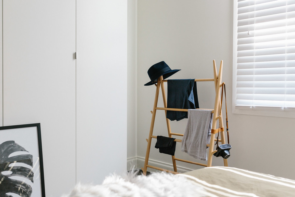 Photo of a mid-sized scandinavian bedroom in Melbourne.