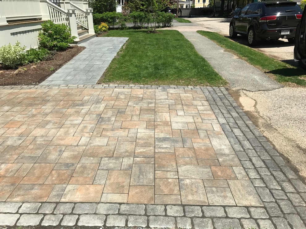 Photo of a mid-sized country front yard full sun driveway in Boston with concrete pavers.