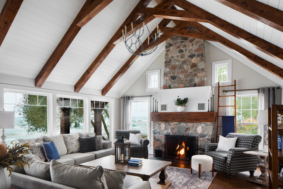 Design ideas for a transitional open concept living room in Milwaukee with grey walls, dark hardwood floors, a standard fireplace, a stone fireplace surround, brown floor, exposed beam, timber, vaulted and no tv.