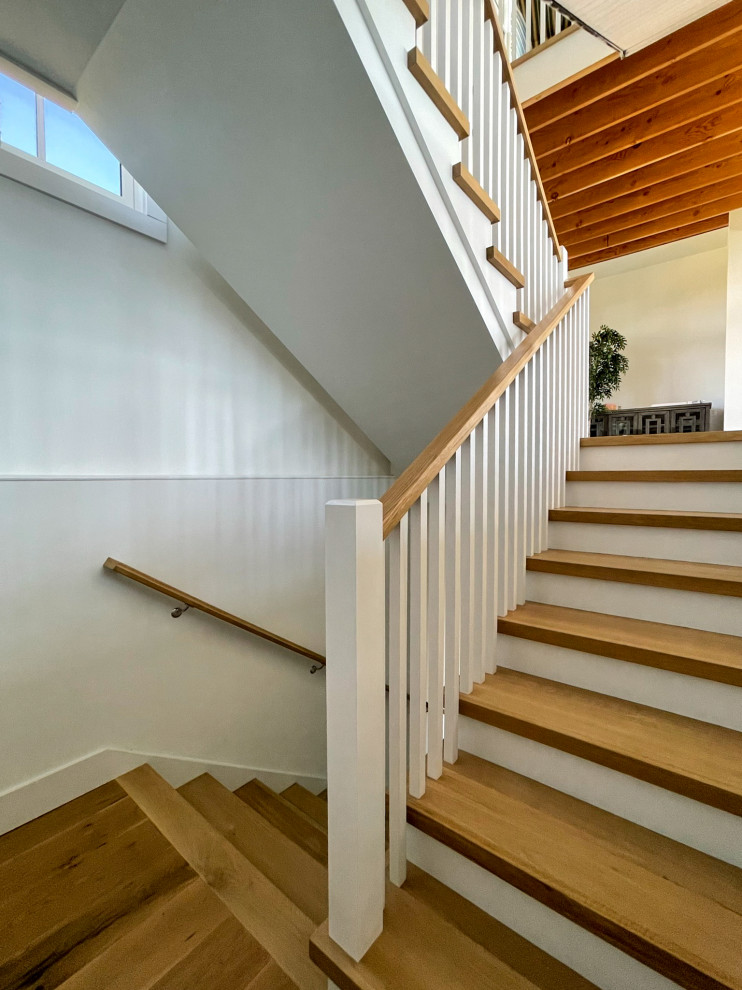Photo of a medium sized rural wood u-shaped wood railing staircase in DC Metro with wood risers and tongue and groove walls.