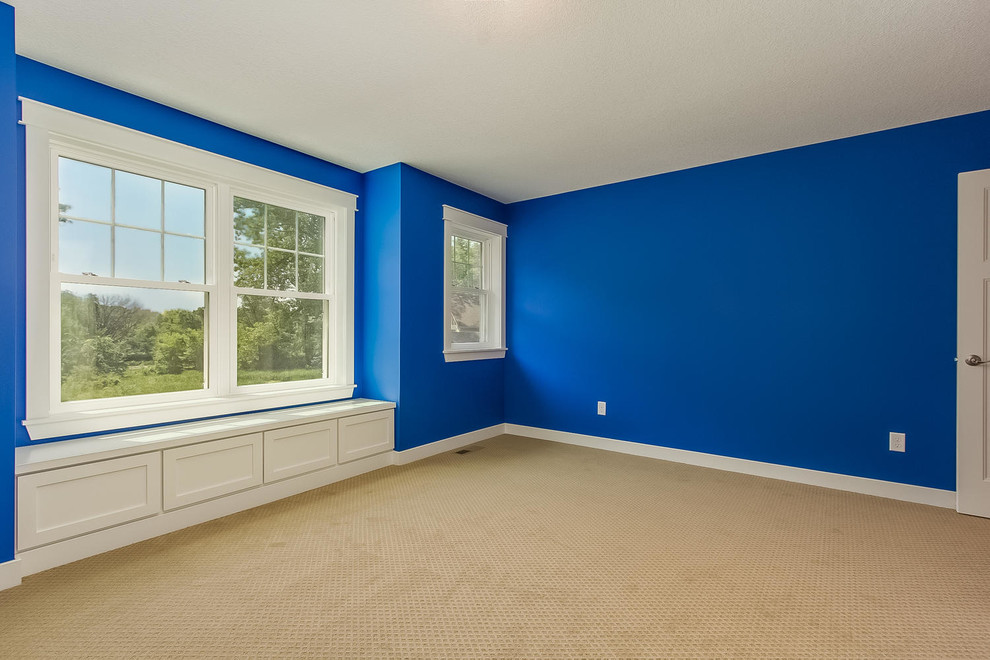 This is an example of a mid-sized country bedroom in Minneapolis with blue walls, carpet and no fireplace.