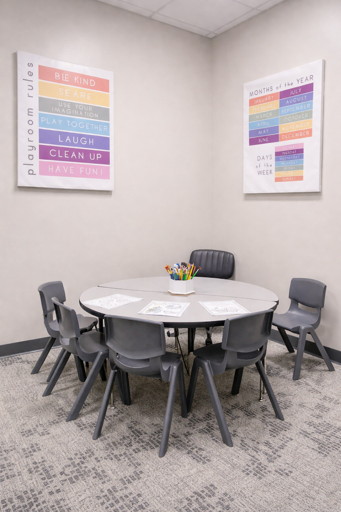 Activity table corner with playroom posters, Radical Minds northwest Omaha